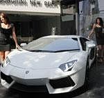 Models pose near the newly launched Lamborghini Aventador LP-700-4 car in New Delhi, India, Thursday, Nov. 3, 2011. The sports car has a 6.5 liter 12 cylinder 700 horsepower engine which helps the car achieve 0 to 100 kilometers per hour (0 to 62 miles per hour) in 2.9 seconds, according to a company release. The car is priced at Rupees 36,900,000 (US $768,750). AP Photo