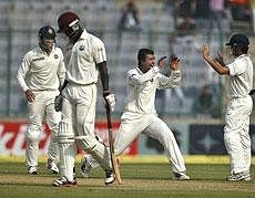 West Indian captain Darren Sammy (centre) celebrates with Carlton Baugh after dismissing Indian captain MS Dhoni. AFP