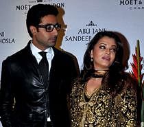 Indian Bollywood actors Abhishek Bachchan (L), with wife Aishwarya Rai Bachchan (R) pose for a photo during a party. AFP