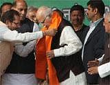Senior BJP leader L K Advani being welcomed by party leader Mukhtar Abbas Naqvi at a public meeting during his "Jan Chetna Yatra" in Rampur on Saturday. PTI