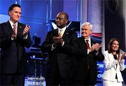Republican presidential candidates from left, former Massachusetts Gov. Mitt Romney, businessman Herman Cain, former House Speaker Newt Gingrich, and Rep. Michele Bachmann, R-Minn., applaud on stage before a Republican presidential debate in Washington, Tuesday, AP