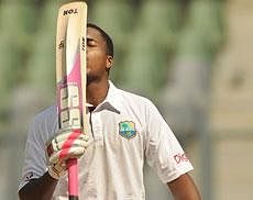 : West Indies batsman Darren Bravo kisses his bat after scoring a century (100 runs) during the second day of the third test cricket match between India and West Indies at the Wankhede stadium in Mumbai on November 23, 2011. AFP