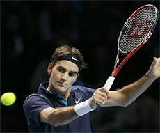 Roger Federer of Switzerland play a return to Jo-Wilfried Tsonga of France during their singles final tennis match at the ATP World Tour Finals, in the O2 arena in London, Sunday. AP Photo