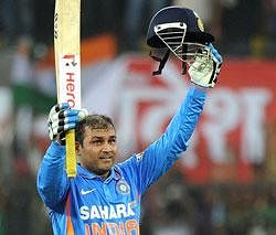 Indian batsman Virender Sehwag celebrates after scoring a double century (200 runs) during the fourth one-day international cricket match between India and West Indies at The Holkar Stadium in Indore on Thursday. AFP