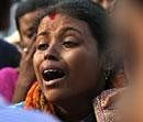 A woman cries as she waits at the airport in Agartala, to receive the body of a relative, one of victims of Friday's fire at a hospital in Kolkata, on Saturday.AP