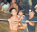 in safe hands: Volunteers rescue residents trapped in flash floods that inundated Cagayan de Oro city, Philippines, on  Saturday. AP