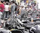 Two-wheelers parked choc-a-bloc on a City road. DH Photos