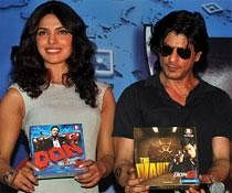 Indian Bollywood personalities Priyanka Chopra (L) and Shah Rukh Khan pose during a promotional event for the "Don 2" board game in Mumbai on December 17, 2011. AFP PHOTO