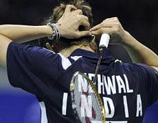 Saina Nehwal of India adjusts his hair against Wang Yihan of China during their women's singles final match at the BWF badminton World Superseries Finals in Liuzhou city, China's southern province of Guangxi on December 18, 2011.Wang Yihan won the match 18-21, 21-13, 21-13. AFP