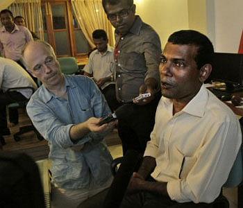 Former President of Maldives Mohamed Nasheed, right, speaks with reporters at his residence in Male, Maldives, Thursday, Feb. 9, 2012. A criminal court in the Maldives has issued an arrest warrant for Nasheed, who stepped down from power earlier this week but later insisted he had been ousted in a coup.AP Photo
