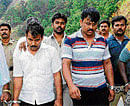 The alleged killers being taken into custody after the body was identified at Charmadi Ghat in Chikmagalur on Thursday. PTI