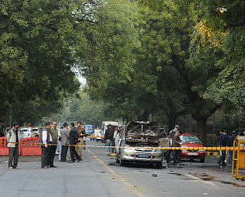 Investigators work the scene of a vehicle that exploded near the Israeli embassy in New Delhi.  AFP