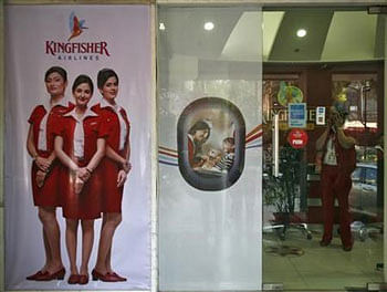 An employee speaks on a mobile phone inside a Kingfisher Airlines city office in New Delhi. Reuters File Photo