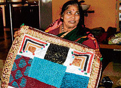Stitching Memories Nirmalakka with her quilts. Photo by Chethana Dinesh