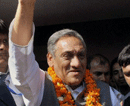Congress leader and Uttarakhand Chief Minister-designate Vijay Bahuguna greets party workers at his residence in Dehradun on Tuesday. PTI Photo