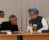 Prime Minister Manmohan Singh talking to Finance Minister Pranab Mukherjee at an all-party meeting of Rajya Sabha members on the Lokpal Bill, at PM House in New Delhi on Friday. PTI