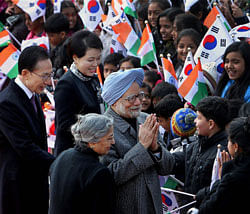 Prime Minister Manmohan Singh with his wife Gursharan Kaur with South Korean President Lee Myung-bak and his wife Kim-Yoon-ok greeted by Indian and South Korean children during a welcoming ceremony in Seoul, South Korea on Sunday. PTI