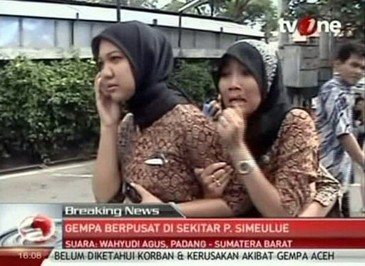 In this image made from Indonesian television TV One, two women react on a street shortly after they ran out from a building when a strong earthquake hit in Aceh in Indonesia, Wednesday, April 11, 2012. A tsunami watch was issued for countries across the Indian Ocean after a large earthquake hit waters off Indonesia on Wednesday, triggering widespread panic as residents along coastlines fled to high ground in cars and on the backs of motorcycles. (AP Photo/TV One via AP Video)