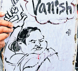 An AISA activist holds a cartoon poster of West Bengal Chief Minister Mamata Banerjee which reads Democracy vanish at a rally in Kolkata on Tuesday. PTI