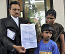 Advocate C. Unnikrisnan showing the cheques for rupees one crore given as compensation to the family members of Jalastine who was allegedly shot dead by Italian marines, at Kerala High Court in Ernakulam on Tuesday. PTI