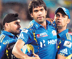 job well done Mumaf Patel (centre) held his nerve in the final over to bowl Mumbai to victory in a nail-biting finish. pti
