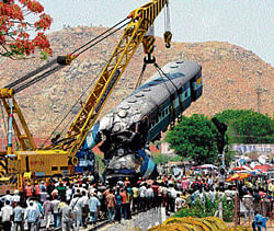 The badly damaged coach of the Hampi Express is being lifted off the track near Penukonda Railway Station in Andhra Pradesh on Tuesday. dh Photo/ Anand Bakshi
