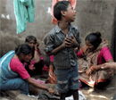 A child and women mourn the death of a boy after a powerful blast in Kareli locality of Allahabad on Wednesday. PTI Photo