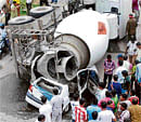Crushed: A concrete mixer that toppled on a car at Nagarabavi Circle on Tuesday. KPN