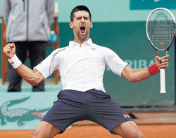 marathon man: Serbias Novak Djokovic celebrates his victory over Frenchman Jo-Wilfried Tsonga in the French Open quarterfinals in Paris on Tuesday. Djokovic will take on Roger Federer in the semifinal. AfP