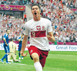 OVER&#8200;THE&#8200;MOON: Poland's Robert Lewandowski celebrates after scoring against Greece  during their Euro 2012 match in Warsaw on&#8200;Friday. REUTERS