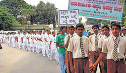 concern: Students participate in a rally to improve awareness against employing child labourers on the occasion of Anti-child Labour Day in Hassan on Tuesday. dh photo