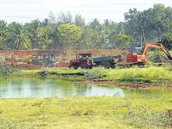fresh Lease of life: Excavators work to clear debris and waste collected at Bogadi Lake in Mysore. dh photos by Mamatha M&#8200;R