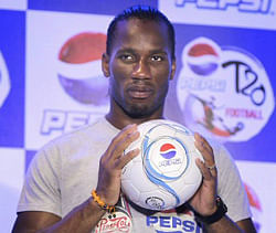 Ivory Coast soccer star Didier Drogba holds a soccer ball during a press conference on "T-20" soccer match in New Delhi on Sunday. PTI