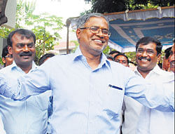relief: Minister Suresh Kumar celebrates with his supporters after the Advocate General  exonerated him in the site allotment controversy. DH photo