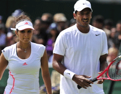 India's Sania Mirza (L) with India's Mahesh Bhupathi during their second round mixed doubles match against Australia's Paul Hanley and Russia's Alla Kudryavtseva on day six of the 2012 Wimbledon Championships tennis tournament at the All England Tennis Club in Wimbledon, southwest London, on June 30, 2012. AFP