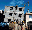 Rescue act: Fire personnel at the spot where a four-storey building collapsed at  Garudacharpalya near Mahadevapura on Wednesday. DH Photo