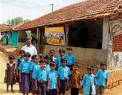 bleak future: Teacher Narayan seen with students of Government Lower Primary School at Kadanuru Koppal in Arkalgud taluk, Hassan district.  dh photo