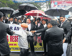 Members of Mangalore Bar Council burn the effigy of Union HRD Minister Kapil Sibal as a mark of protest in Mangalore on Wednesday. dh photo