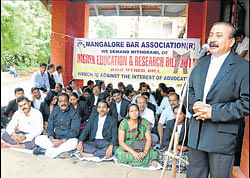 Mangalore Bar Association President S P Changappa addressing the protesters outside District Court on Thursday.