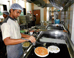 skilled One of the cooks preparing the dosas.