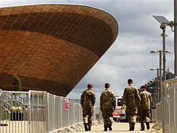 Soldiers walk past the Velodrome at the London 2012 Olympic Park in Stratford, east London July 13, 2012.  Credit: Reuters