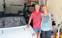 Robert Russell and wife with the stolen car back in their Texas garage. The 1967 Austin Healy sports car was  recovered after it was spotted on eBay. AP