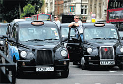 engines off: London taxi drivers stage a protest against their exclusion from the Olympic lanes on Tuesday. AFP