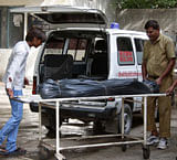 Hospital staff move the covered body of Awanish Kumar Dev, human resources manager at Maruti Suzuki plant in Manesar, from a hospital morgue in Gurgaon July 19, 2012. A deadly riot at the Manesar factory of carmaker Maruti Suzuki shut the plant on Thursday and inflicted the biggest loss on its share price in almost two years. Dev was burned to death during the riot, the company said. REUTERS