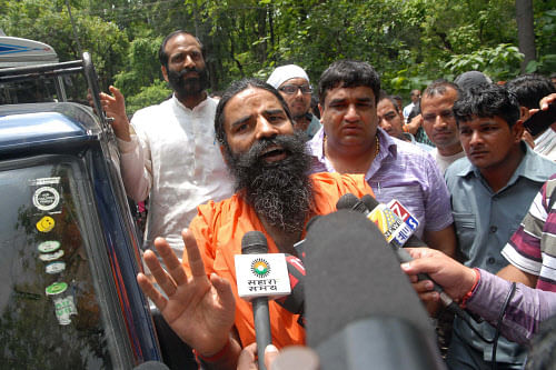 Indian spiritual guru Baba Ramdev addresses journalists in Dehradun on July 21, 2012, following the arrest of Ramdev's close aide Acharya Balkrishna. The Central Bureau of Investigation (CBI) arrested yoga guru Baba Ramdev's close aide Acharya Balkrishna July 20 in a case relating to submission of alleged fake and forged documents to obtain an Indian passport, reports said. A bail application by Balkrishna was rejected by a special CBI court July 21. AFP