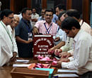 Election observers (L) watch officials sort ballot papers from an emptied box as they begin tallying the presidential election results, at the Parliament in New Delhi on Sunday. PTI