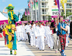 all charged up: Indian contingent marches during the flag-hoisting ceremony at the Games Village on Sunday. PTI