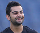 raring to go: Indian captain MS Dhoni and his deputy Virat Kohli share a light moment at Mondays training session. reuters