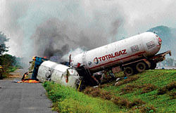 Fatal collision: The gas tanker and the milk tanker that overturned and caught fire in  Kunigal on Monday. DH Photo