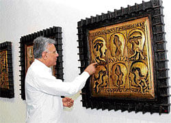 interpreting Naresh Kapuria with his wooden reliefs. PHOTOs: chaman gautam